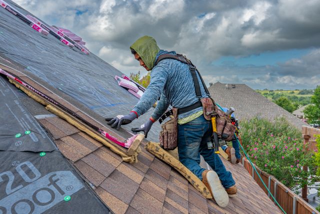 Roofer installing shingles on a home